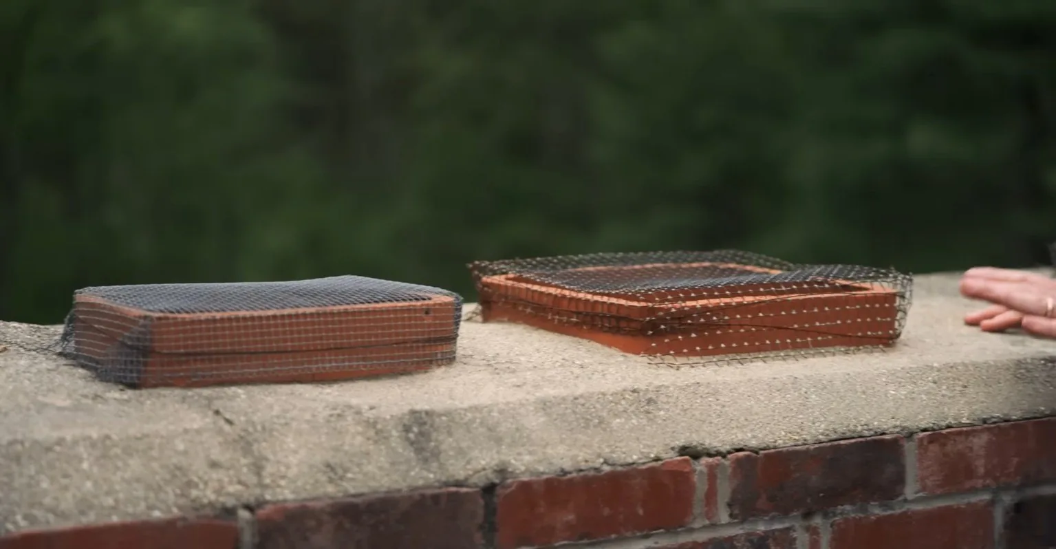Screened clay flue tiles on a chimney crown
